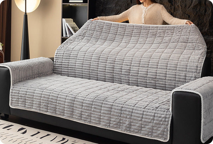 Laying the one-piece cover over a sofa