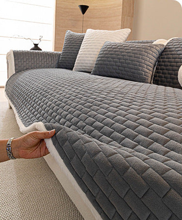 Lifting the grey quilted sofa cover