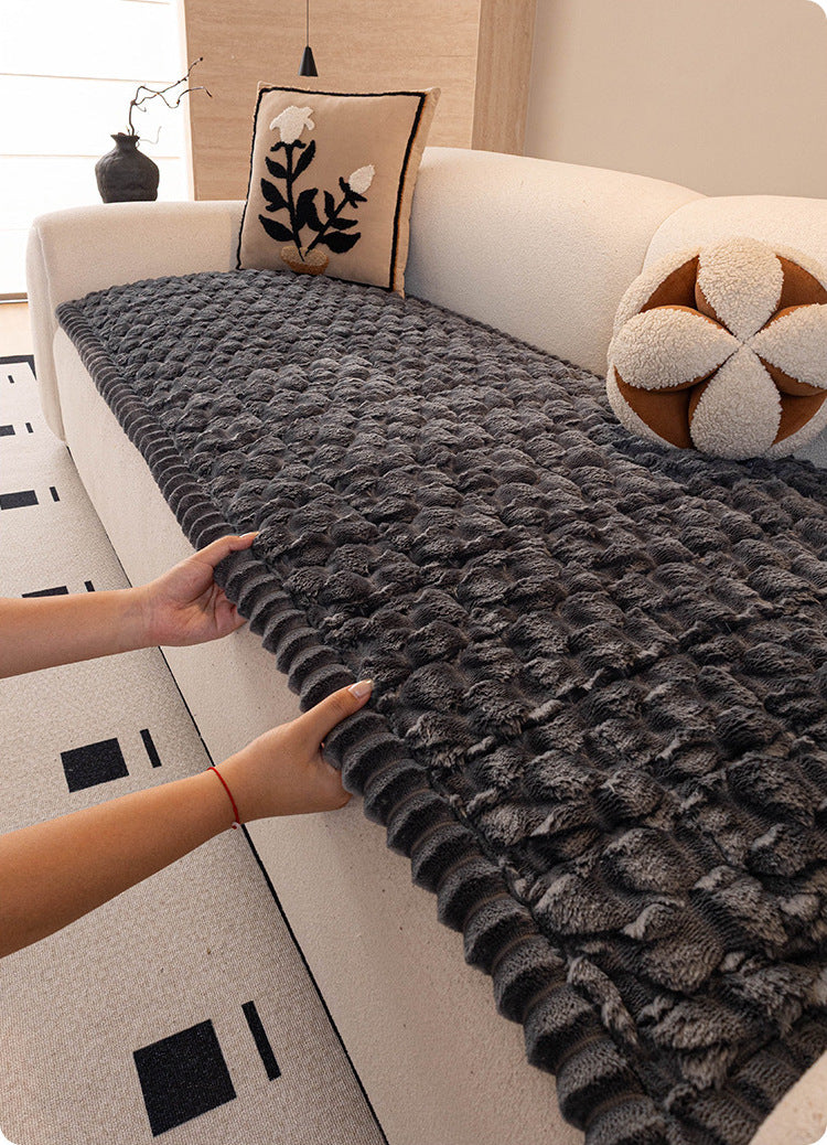 Laying the plush cover on a sofa seat