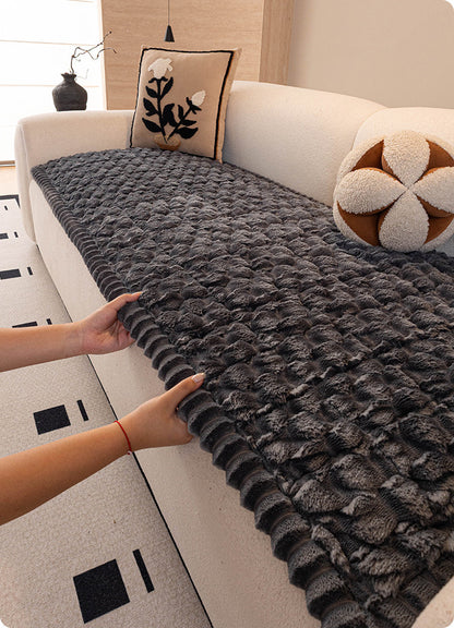 Laying the plush cover on a sofa seat