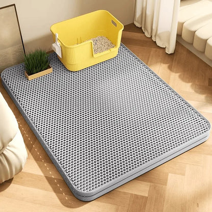 Gray litter mat under a litter box in a living room