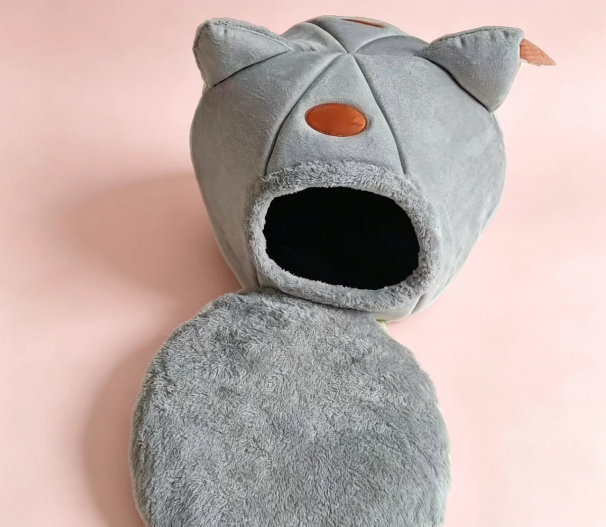 Light gray cave cat bed with its fluffy cushion
