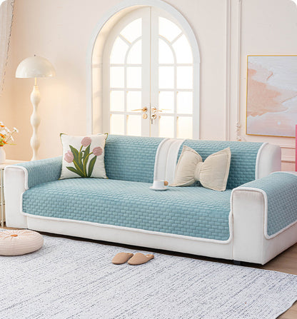 Blue quilted sofa cover on a full sofa